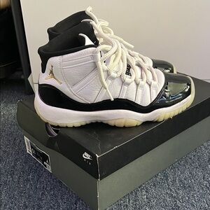 Nike Air Jordan 11 Retro in White, Black, and Gold